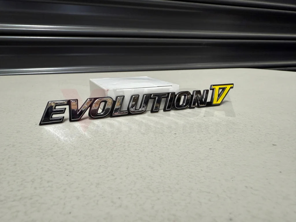 Rear ’Evolution V’ Emblem to suit Mitsubishi Lancer Evolution 5 CP9A MR388458 Emblems Badges and Decals