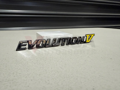 Rear ’Evolution V’ Emblem to suit Mitsubishi Lancer Evolution 5 CP9A MR388458 Emblems Badges and Decals